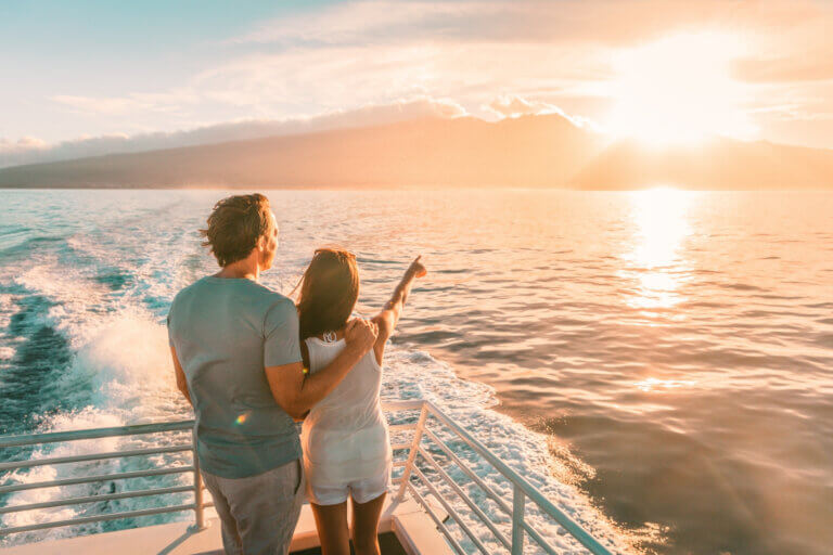 Man and woman on a boat watching the sunset
